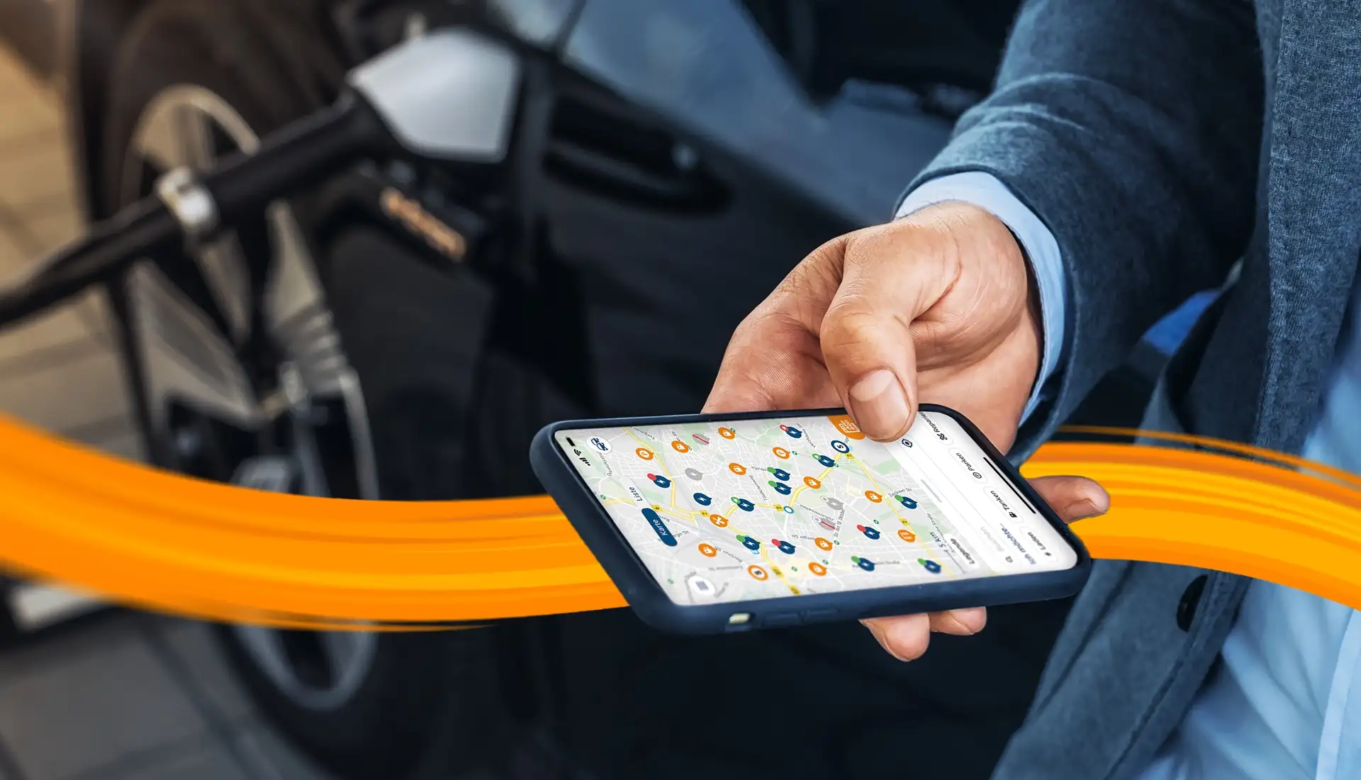 person charging emobility car while looking onto his phone