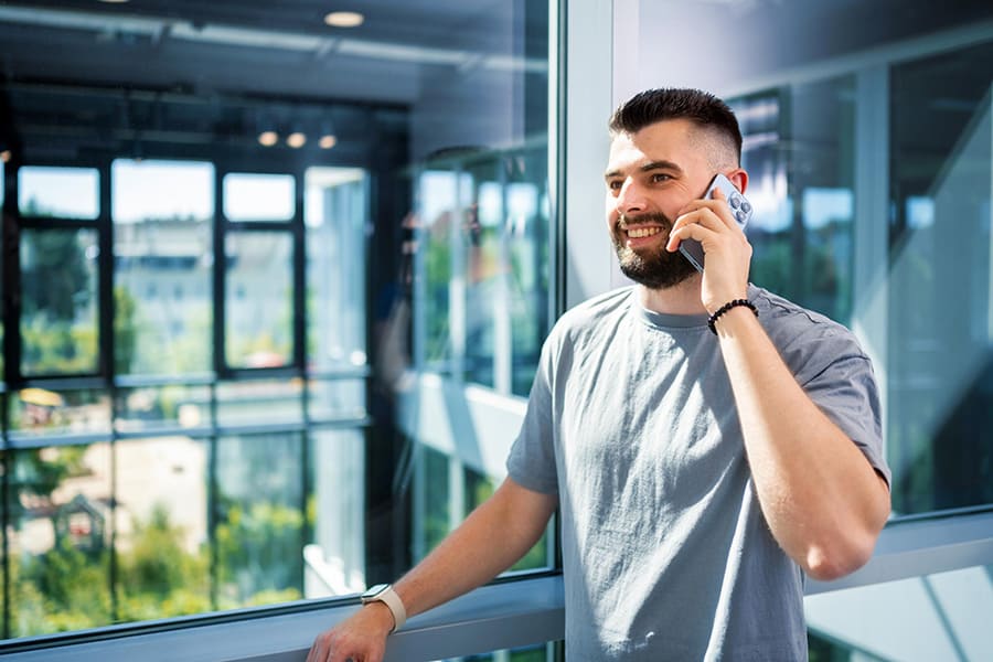 Man sitting at his desk and talking on the phone