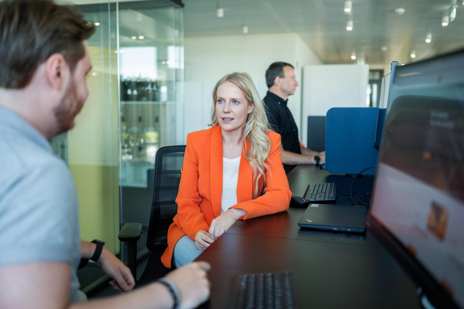 people talking at desk