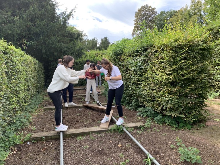 Young people overcoming an obstacle course