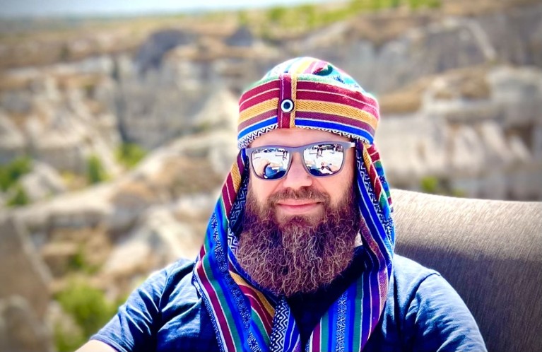 Movember participant with beard and cap