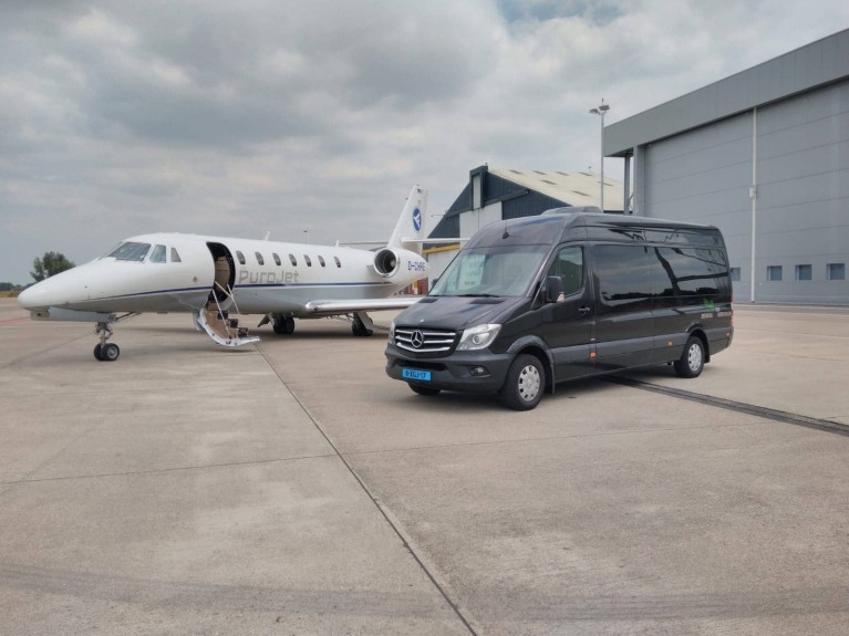 Car of Beerens Passenger Transport next to a private jet