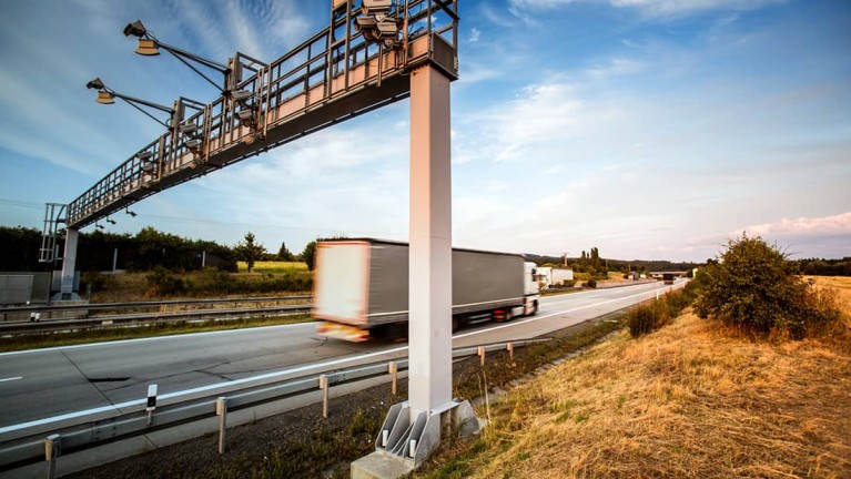 Truck crossing a toll station on the motorway.