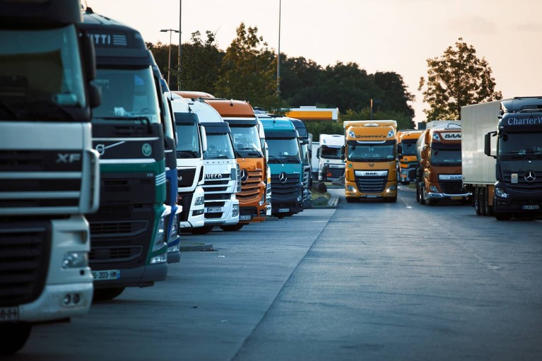 Many trucks parking on a highway parking lot