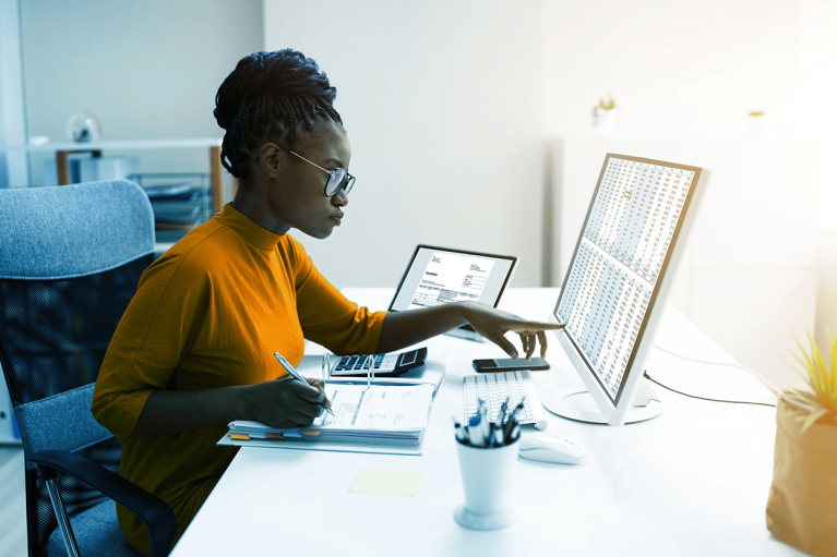 woman sits in front of laptop