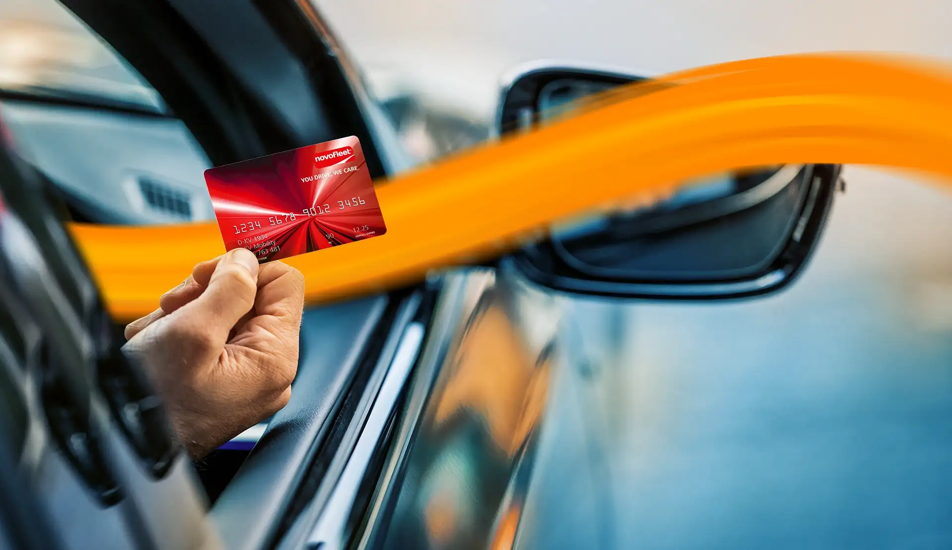 person holding DKV card out of the cars window