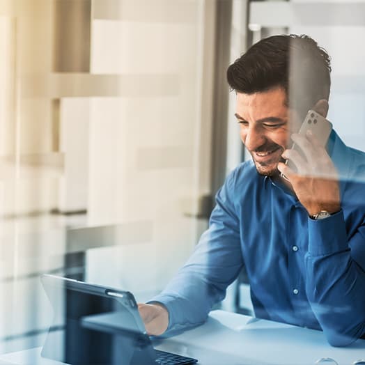 Man on the phone while using tablet