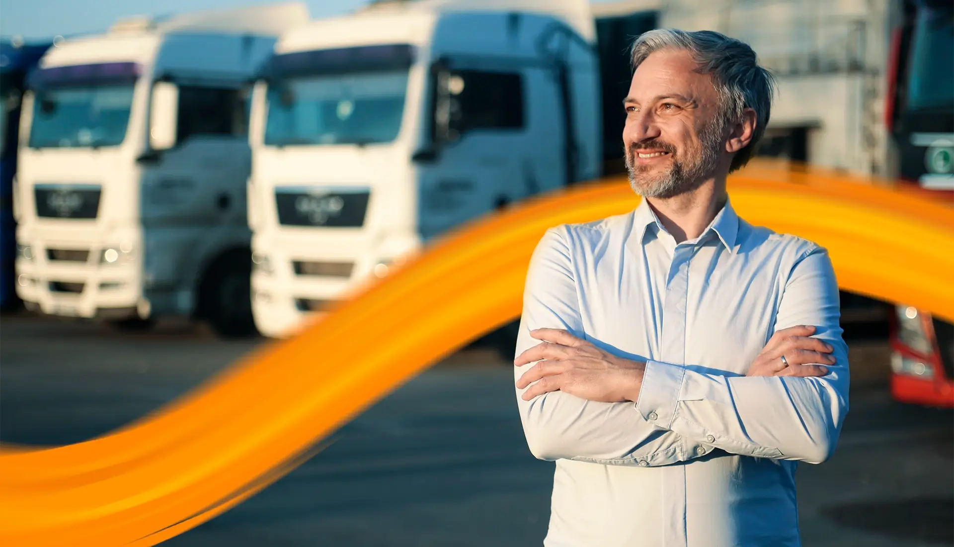 Vehicle fleet manager in front of trucks and the warehouse
