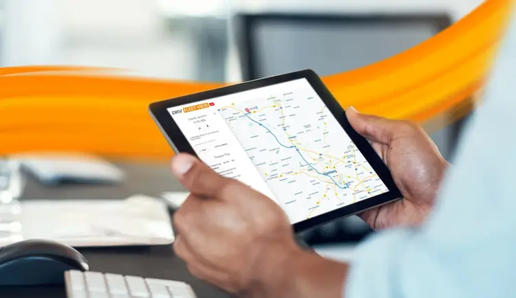 hand holding tablet woith DKV Fleet View on it