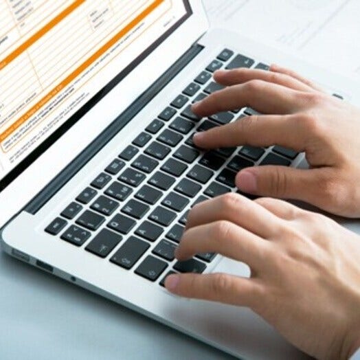 man in front of a laptop