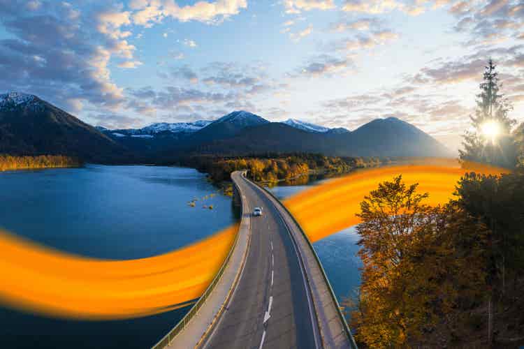 hand holding DKV card in front of a laptop