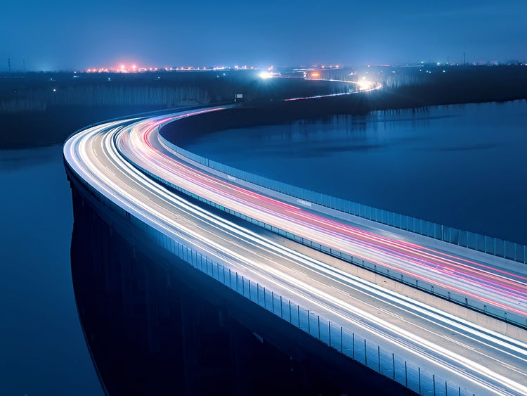 Highway road at night - Car lights passing by