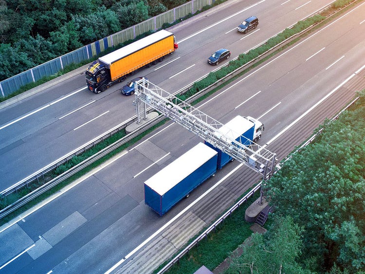 Trucks passing toll stations on highway